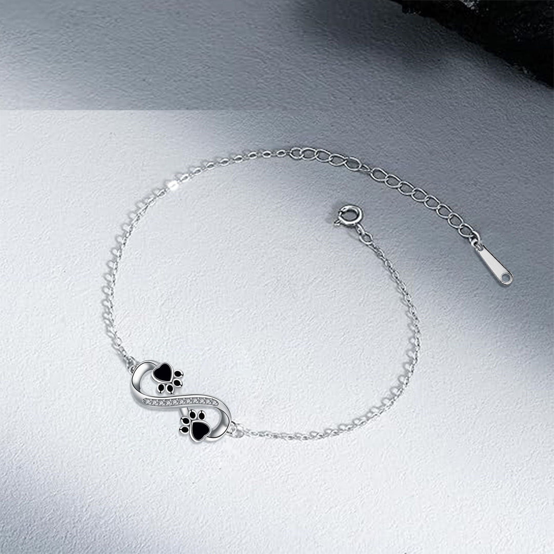Bracelet avec symbole de l'infini, charms avec empreinte de patte et zircons